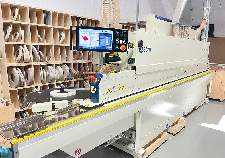 CNC precision cutting on wooden boards for kitchen furniture